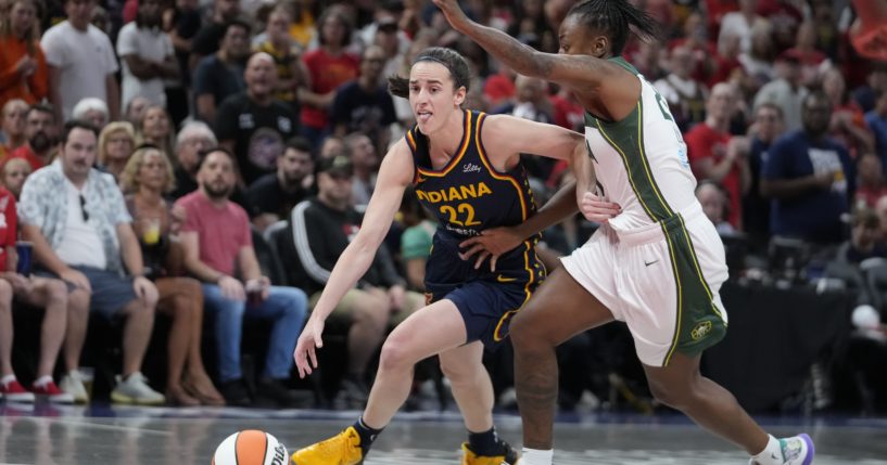 Indiana Fever's Caitlin Clark goes to the basket against Seattle Storm's Jewell Loyd, right, during the first half of a WNBA basketball game on Aug. 18 in Indianapolis.