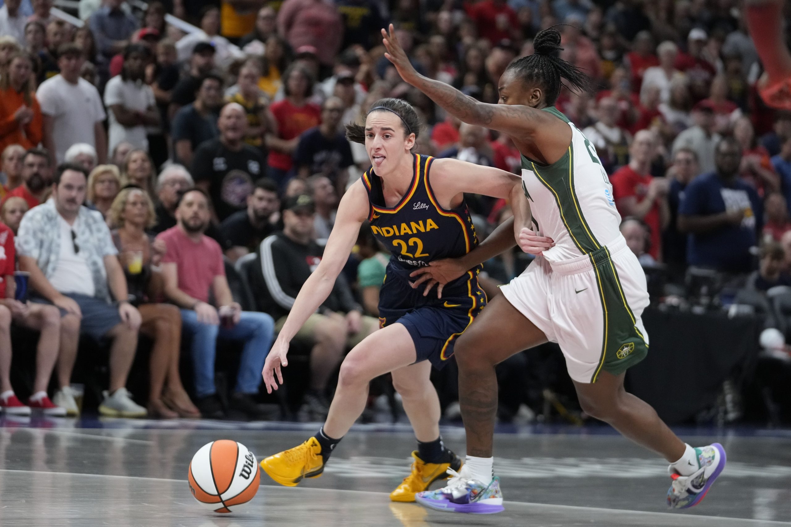 Indiana Fever's Caitlin Clark goes to the basket against Seattle Storm's Jewell Loyd, right, during the first half of a WNBA basketball game on Aug. 18 in Indianapolis.