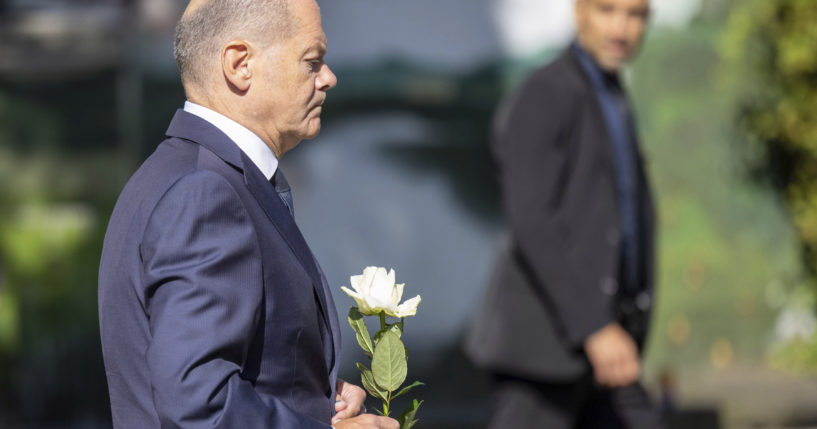 Germany Chancellor Olaf Scholz lays a flower at a church, near the scene of a knife attack, in Solingen, Germany on Monday.