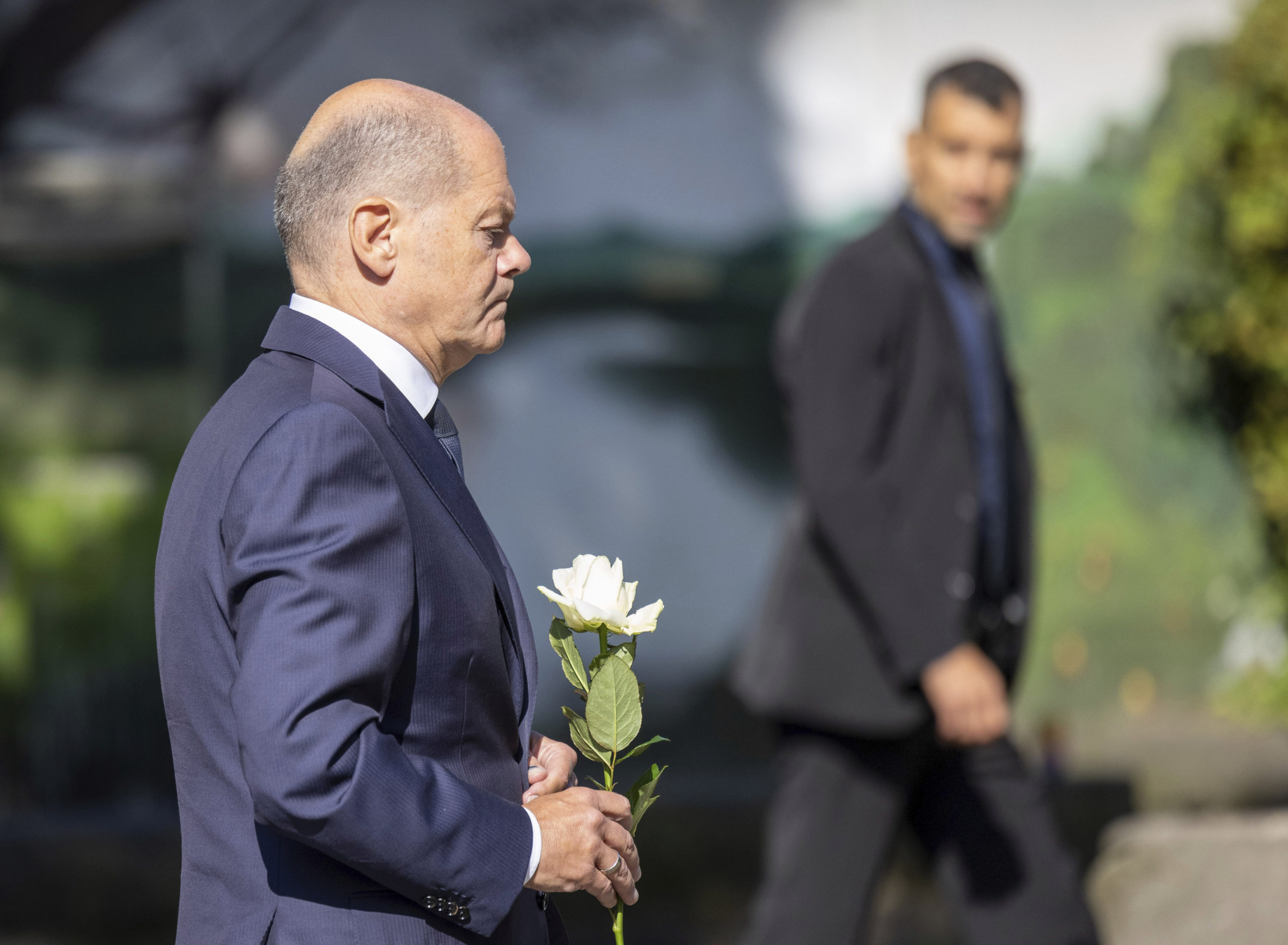 Germany Chancellor Olaf Scholz lays a flower at a church, near the scene of a knife attack, in Solingen, Germany on Monday.