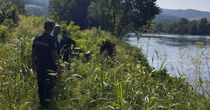 In this photograph made available by the Serbian Ministry of Interior, Serbian Police officers search a bank of the Drina River near the town of Ljubovija, Serbia on Thursday.