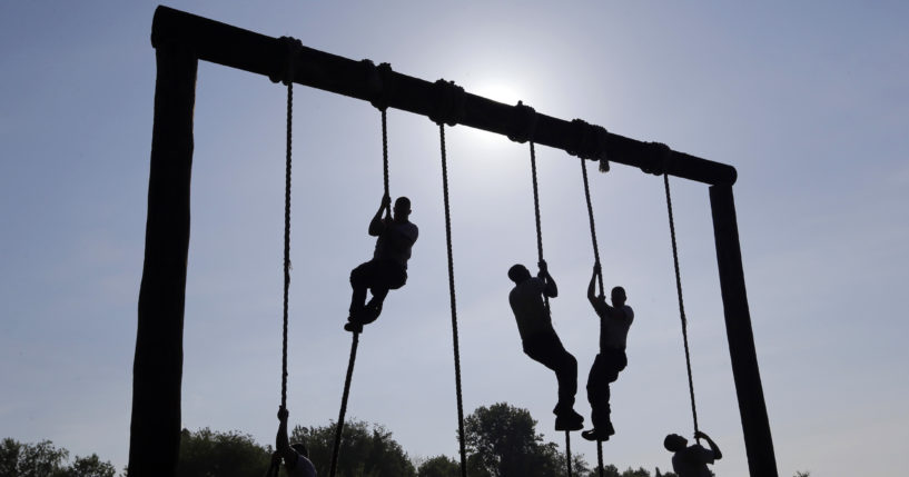 Freshman midshipmen, known as plebes, climb ropes on an obstacle course during Sea Trials, a day of physical and mental challenges that caps off the freshman year at the U.S. Naval Academy in Annapolis, Msryland, on May 13, 2014.