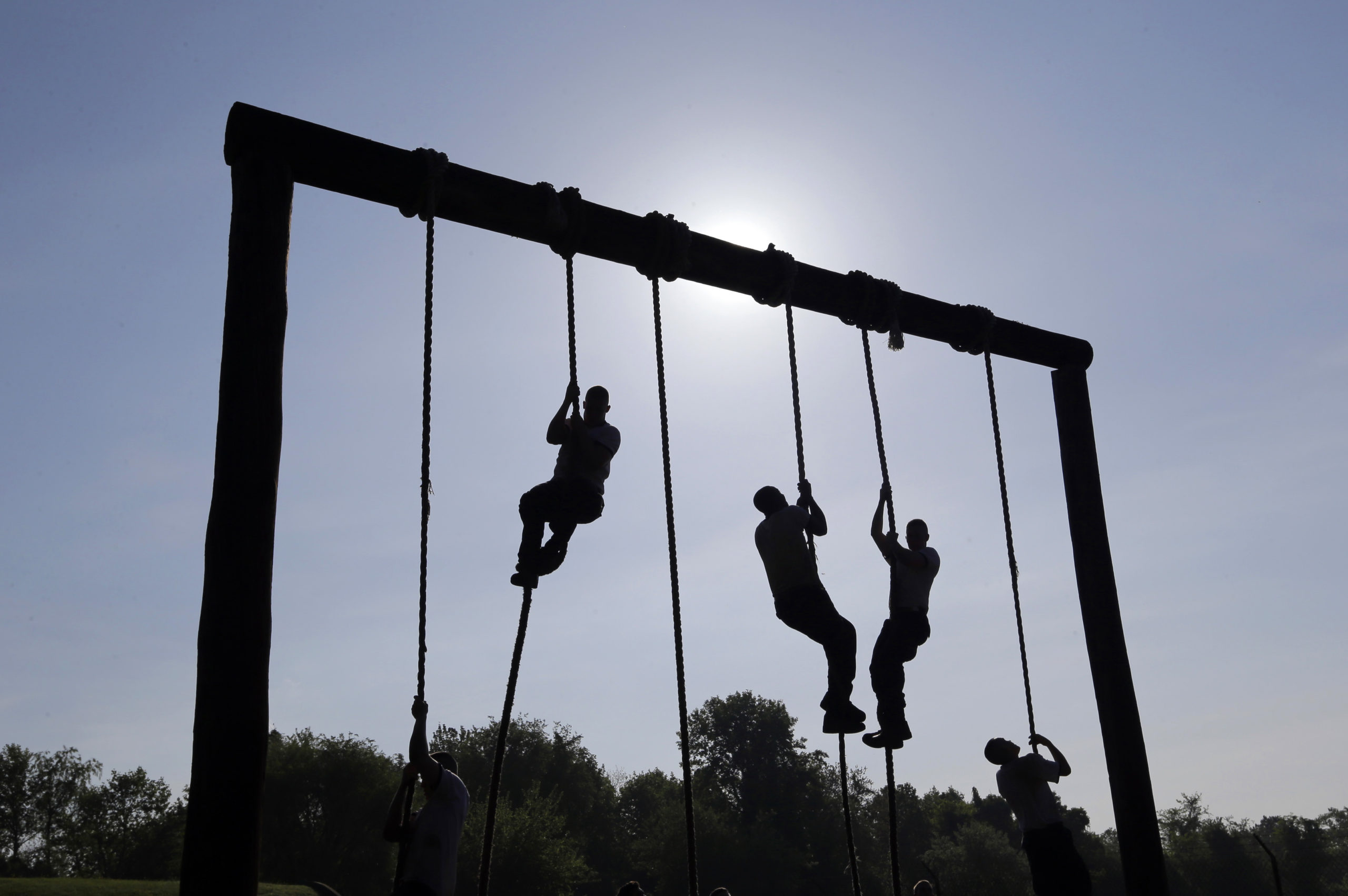 Freshman midshipmen, known as plebes, climb ropes on an obstacle course during Sea Trials, a day of physical and mental challenges that caps off the freshman year at the U.S. Naval Academy in Annapolis, Msryland, on May 13, 2014.