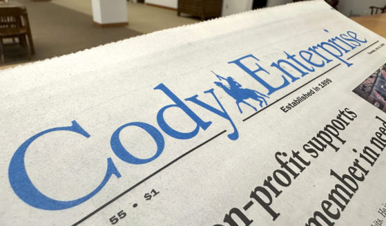 A recent issue of the Cody Enterprise, the Wyoming newspaper where a reporter used artificial intelligence to help write his stories, is seen Tuesday at the Wyoming State Library in Cheyenne.