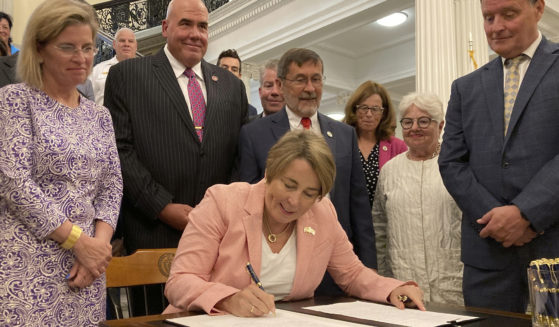 Massachusetts Gov. Maura Healey signs into law a bill that would phase out the use of PFAS, a group of toxic industrial compounds, in firefighters' protective gear, at the Massachusetts Statehouse, Thursday in Boston.