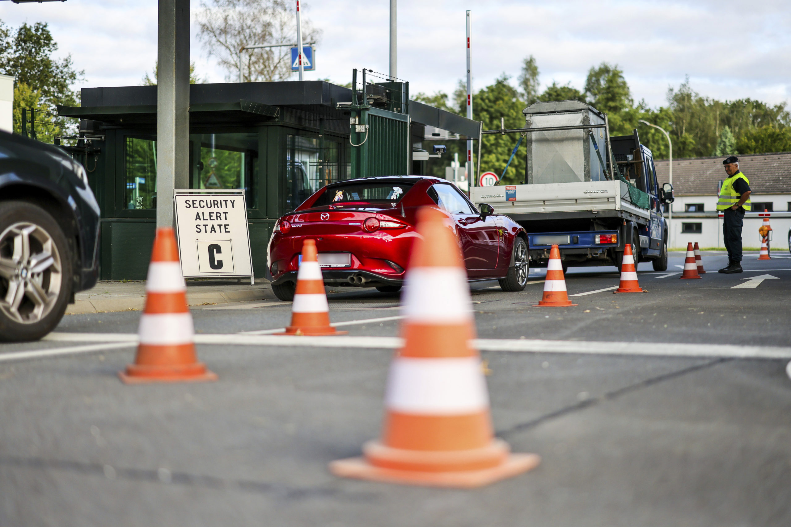 Soldiers check the entrance to the NATO air base, in Geilenkirchen, Germany on Friday, with the security alert state C sign on the left.