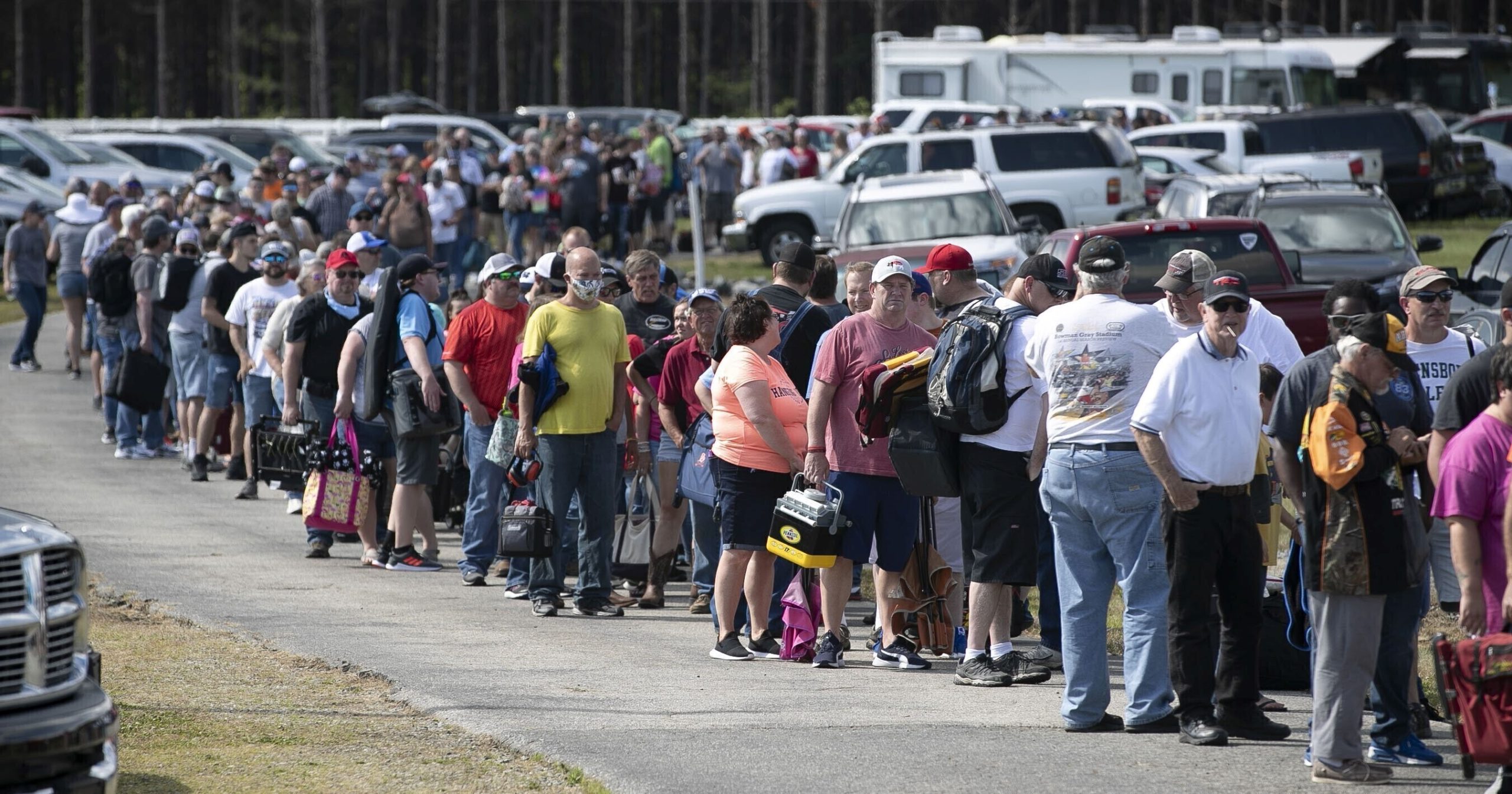 Hundreds of race fans wait in line to purchase tickets at the Ace Speedway in the rural Alamance County community of Altamahaw near Elon, North Carolina, on May 23, 2020.