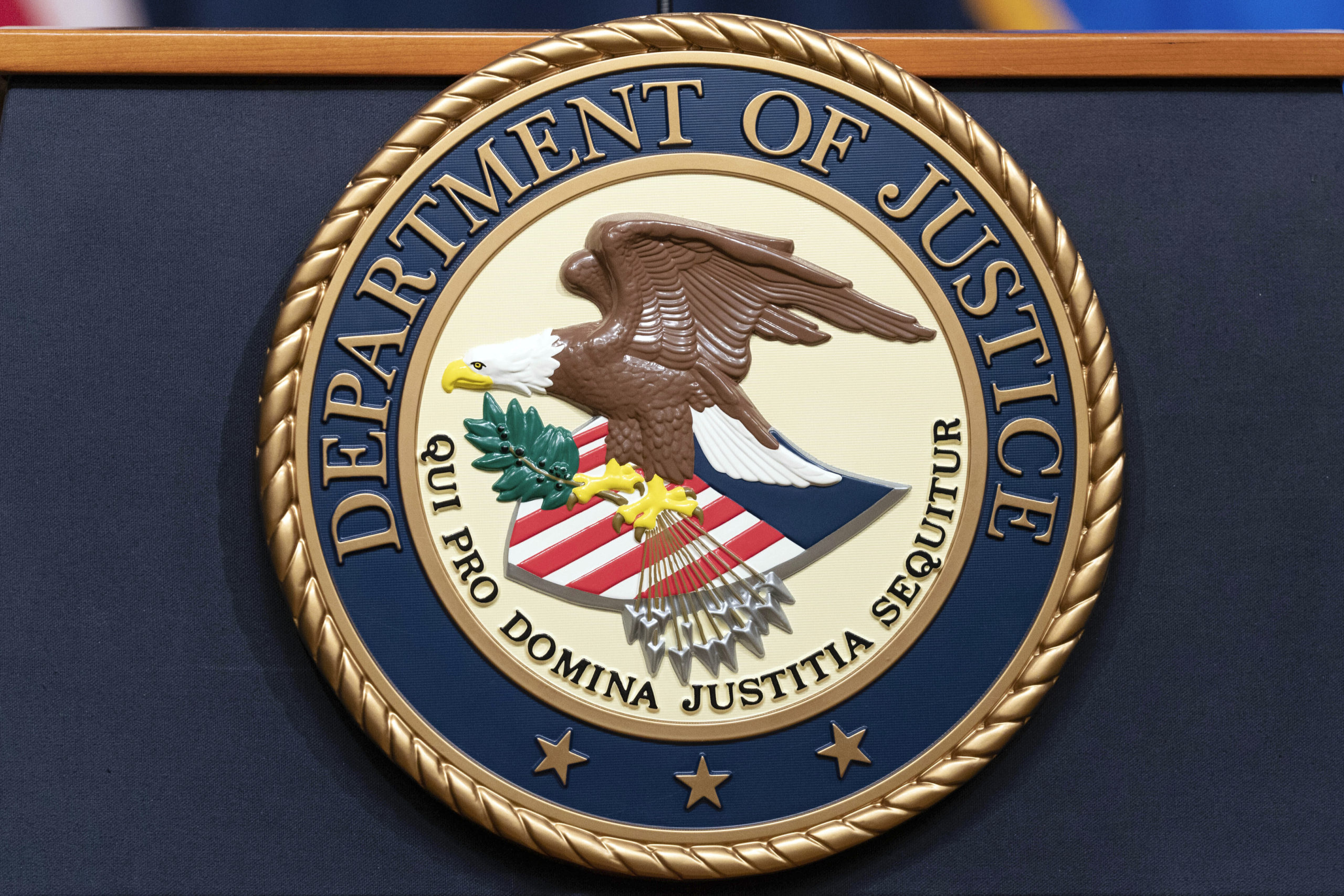 The Department of Justice seals is seen during a news conference at the DOJ office in Washington, May 16, 2023.