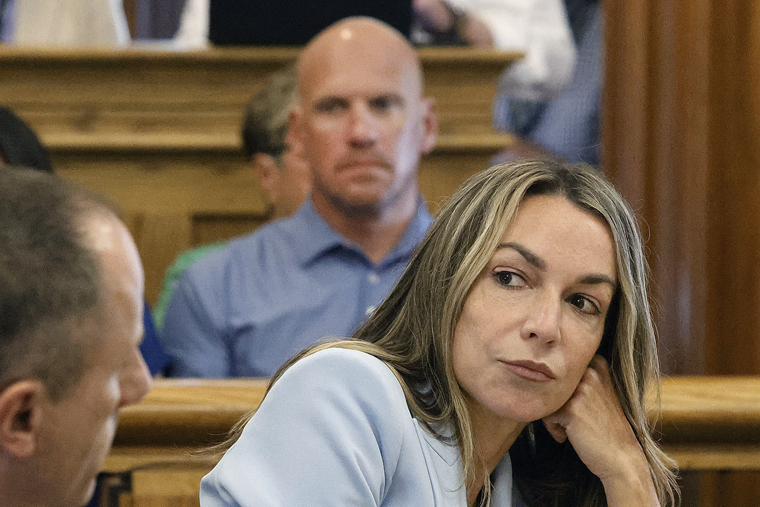 Karen Read listens to her attorney, Martin Weinberg, who was making motions to dismiss two charges against her, at Norfolk Superior Court, in Dedham, Massachusetts, Friday, August 9, 2024.