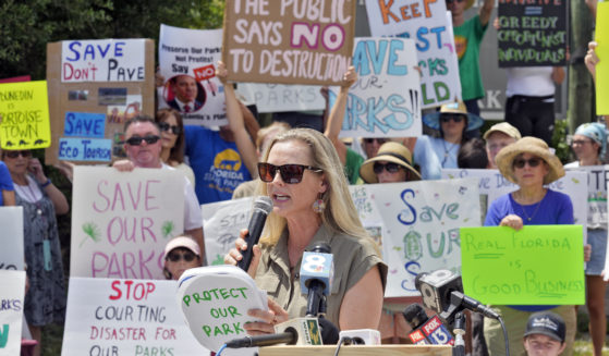 Democratic Florida State Rep. Lindsay Cross speaks to supporters against development at Florida state parks outside the entrance to Honeymoon Island State Park on Tuesday in Dunedin, Florida.