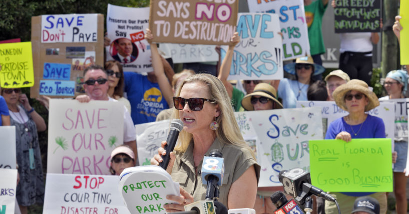 Democratic Florida State Rep. Lindsay Cross speaks to supporters against development at Florida state parks outside the entrance to Honeymoon Island State Park on Tuesday in Dunedin, Florida.