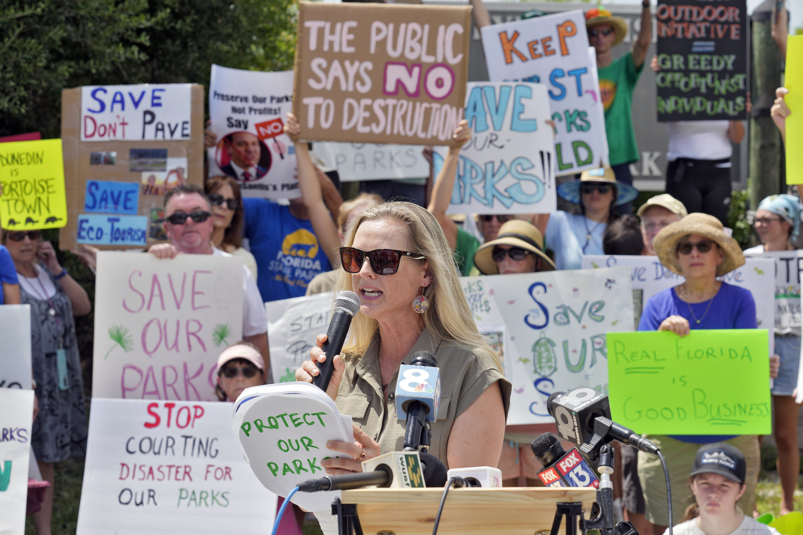 Democratic Florida State Rep. Lindsay Cross speaks to supporters against development at Florida state parks outside the entrance to Honeymoon Island State Park on Tuesday in Dunedin, Florida.