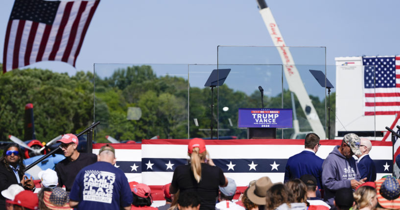 An outdoor stage is set encased with bulletproof glass as supporters arrive to hear Republican presidential nominee former President Donald Trump speak at a rally on Wednesday in Asheboro, North Carolina. Trump is holding his first outdoor rally since narrowly surviving an attempted assassination when a a gunman opened fire in Pennsylvania last month.