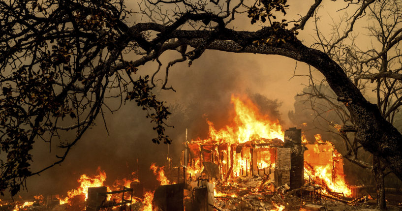 Flames consume a structure on Bessie Lane as the Thompson Fire burns in Oroville, California, July 2, 2024.