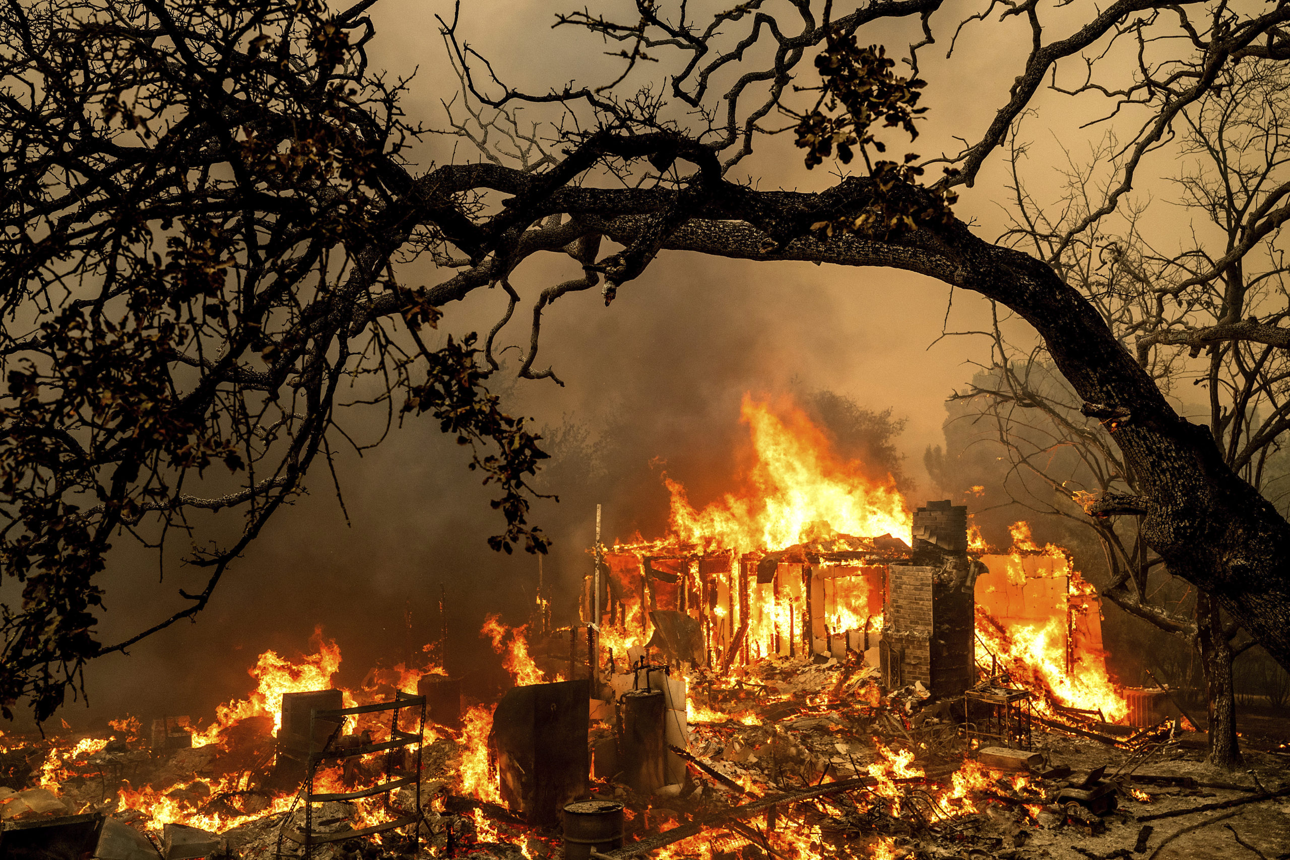 Flames consume a structure on Bessie Lane as the Thompson Fire burns in Oroville, California, July 2, 2024.