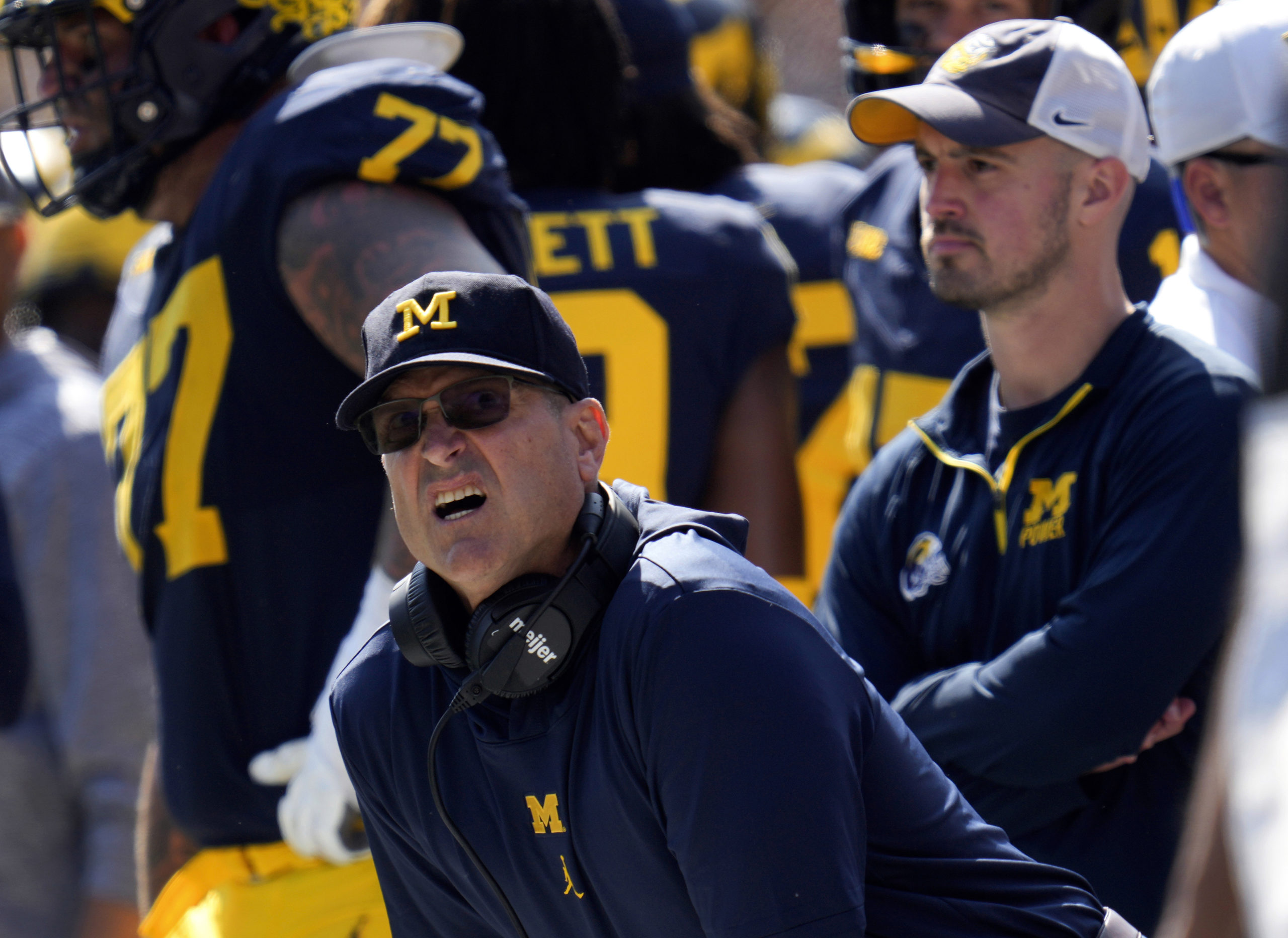 Michigan head coach Jim Harbaugh, front left, watches against Rutgers as analytics assistant Connor Stalions, right, looks on during an NCAA college football game in Ann Arbor, Michigan, September 23, 2023. Stalions is set to share his side of the story from an alleged sign-stealing scheme within Michigan’s football team before it went on to win the national championship.