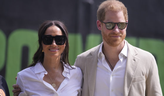 Prince Harry, right, and Meghan attend the Giant of Africa Foundation at the Dream Big Basketball clinic in Lagos Nigeria, on May 12.