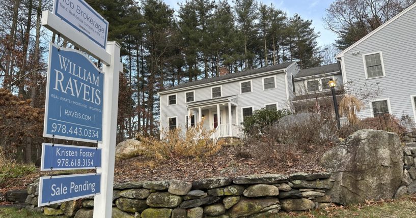 A sale pending sign is displayed in front of a home in Sudbury, Massachusetts on Dec. 2, 2023.