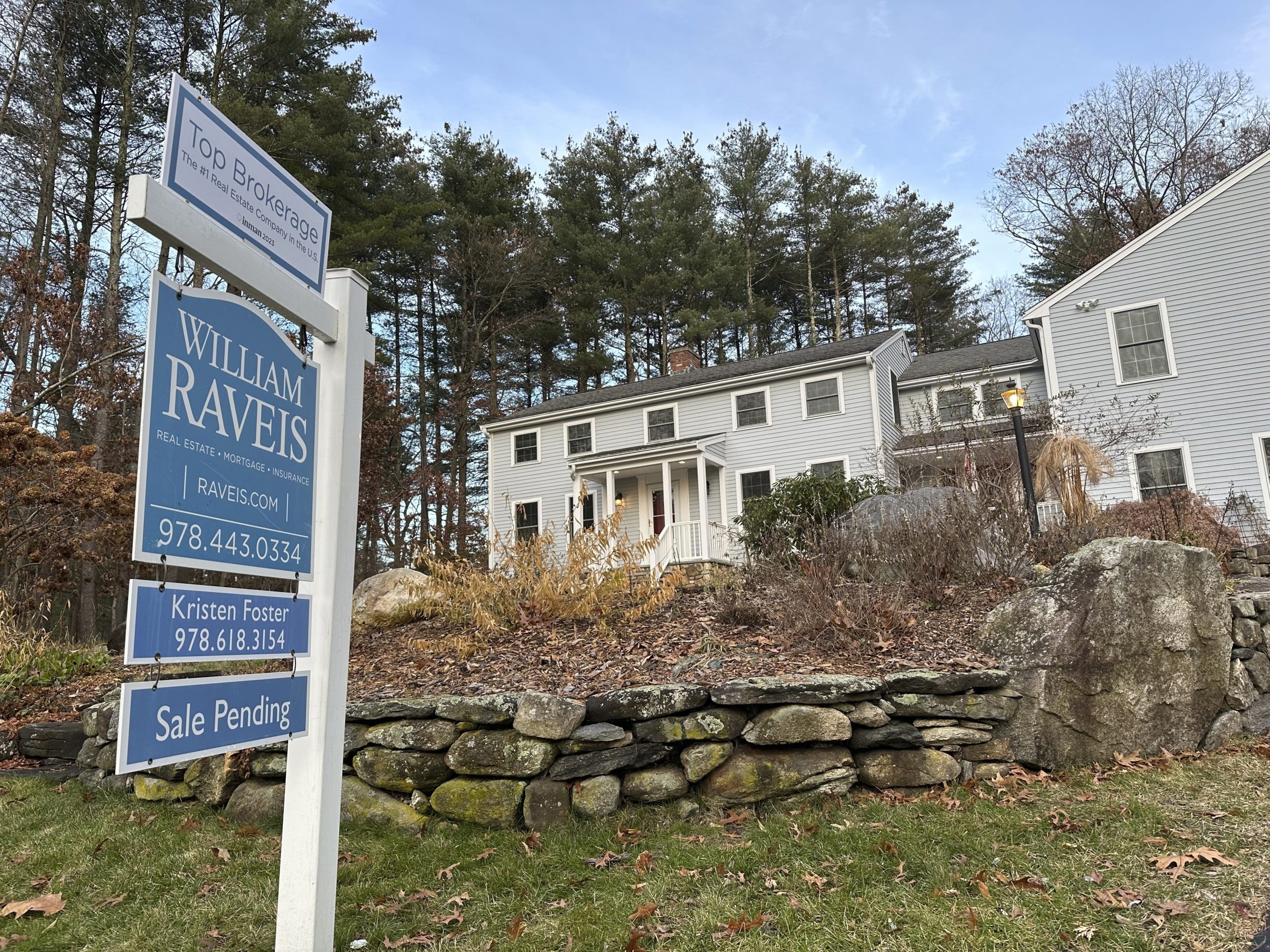 A sale pending sign is displayed in front of a home in Sudbury, Massachusetts on Dec. 2, 2023.