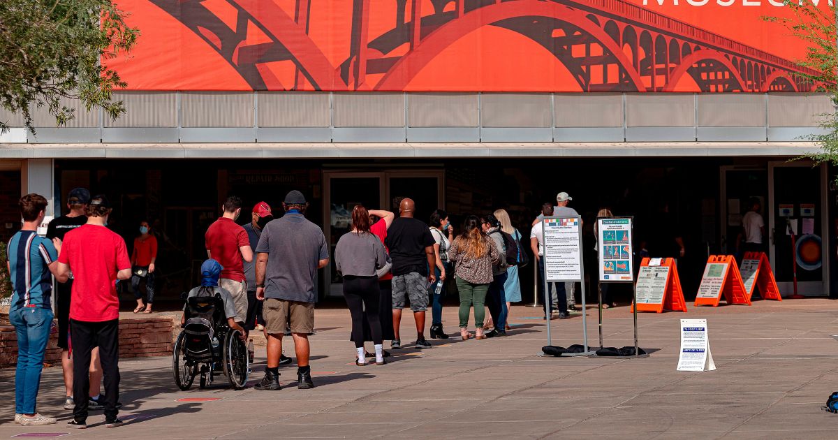 People wait in line to vote outside a polling place at Tempe History Museum, in Tempe, Arizona, on Nov. 3, 2020.