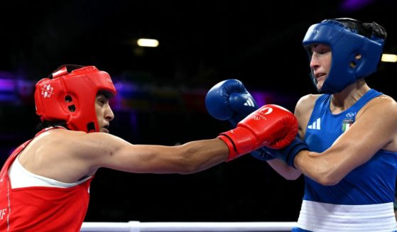 Italian boxer Angela Carini, right, takes a hit from Algerian boxer Imane Khelif, left, during the women's 66kg preliminaries round of 16 boxing match during the Paris 2024 Olympic Games in Villepinte, France, on Thursday.