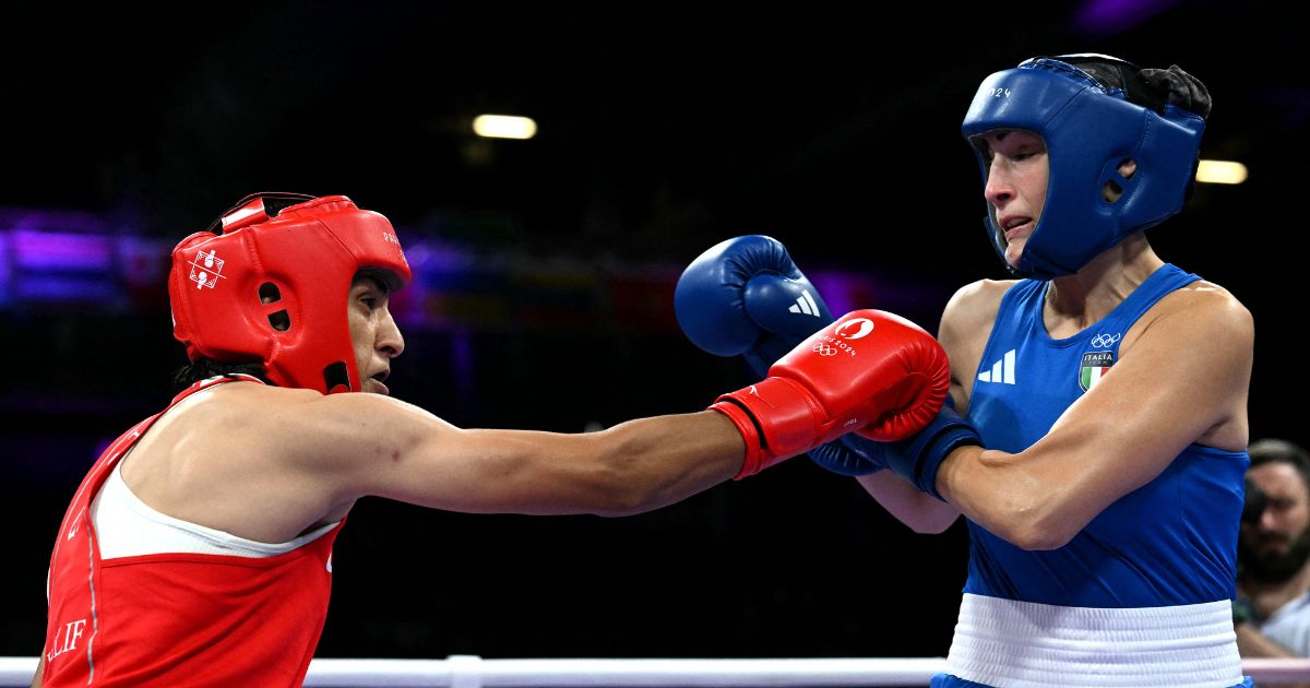 Italian boxer Angela Carini, right, takes a hit from Algerian boxer Imane Khelif, left, during the women's 66kg preliminaries round of 16 boxing match during the Paris 2024 Olympic Games in Villepinte, France, on Thursday.