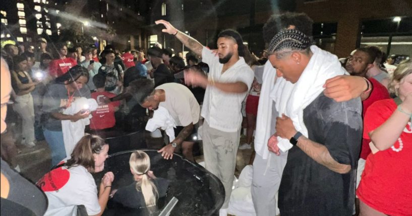 Ohio State football players lead their fellow students in worship and baptism on the campus on Aug. 25.