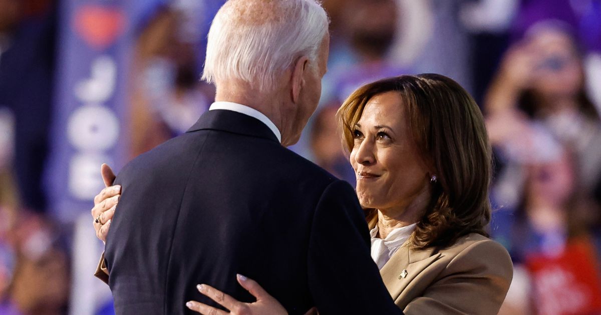 President Joe Biden hugs Vice President Kamala Harris onstage during the first night of the Democratic National Convention in Chicago, Illinois, on Monday.