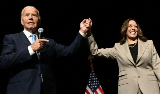 President Joe Biden points to Vice President Kamala Harris in the overflow room after they spoke at Prince George's Community College in Largo, Maryland, on Thursday.