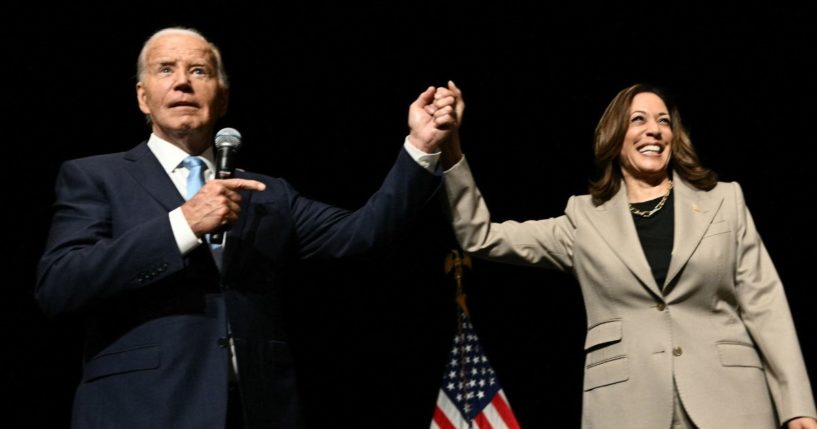 President Joe Biden points to Vice President Kamala Harris in the overflow room after they spoke at Prince George's Community College in Largo, Maryland, on Thursday.