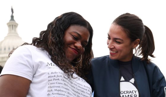 Reps. Cori Bush, left, and Alexandria Ocasio-Cortez, right, embrace during a rally at the U.S. Capitol in Washington, D.C., on Aug. 3, 2021.