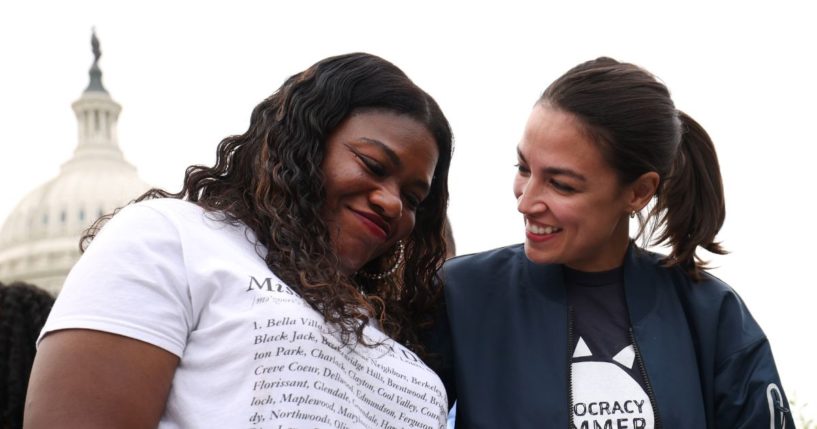 Reps. Cori Bush, left, and Alexandria Ocasio-Cortez, right, embrace during a rally at the U.S. Capitol in Washington, D.C., on Aug. 3, 2021.