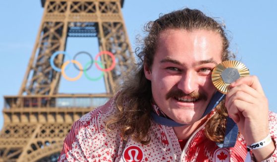 Canadian gold medalist Ethan Katberb poses with his medal in front of the Eiffel Tower during the 2024 Paris Olympic Games on Aug. 6.