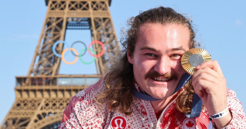 Canadian gold medalist Ethan Katberb poses with his medal in front of the Eiffel Tower during the 2024 Paris Olympic Games on Aug. 6.