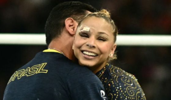 Brazil's Flavia Saraiva reacts with her coach after competing in the uneven bars event of the artistic gymnastics women's team final during the Paris 2024 Olympic Games on July 30.