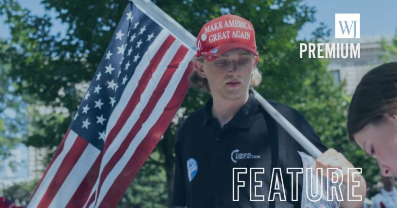 A Trump supporter holds up an American flag during of a prayer vigil in Zeidler Union Square for former President Donald Trump on July 14, in Milwaukee, Wisconsin, one day after an assassination attempt at a Pennsylvania campaign rally.