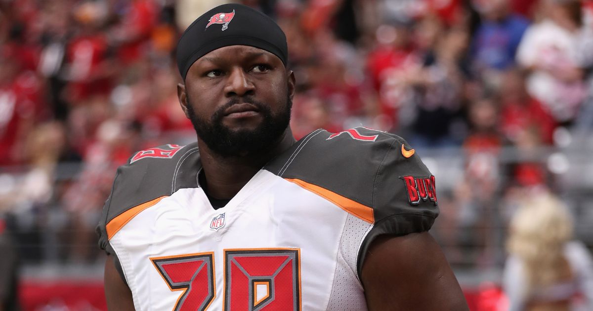 Gosder Cherilus of the Tampa Bay Buccaneers stands on the sidelines during the NFL game against the Arizona Cardinals in Glendale, Arizona, on Sept. 18, 2016.