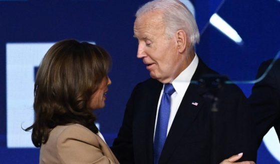 Vice President Kamala Harris, left, and President Joe Biden, right, hug onstage after Biden gave the keynote address on the first day of the Democratic National Convention in Chicago, Illinois, on Aug. 19.