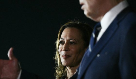 Vice President Kamala Harris looks on as President Joe Biden talks to the media after the arrival of the prisoners released by Russia at Joint Base Andrews in Maryland on Thursday.