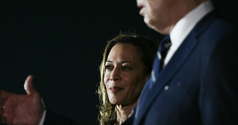 Vice President Kamala Harris looks on as President Joe Biden talks to the media after the arrival of the prisoners released by Russia at Joint Base Andrews in Maryland on Thursday.