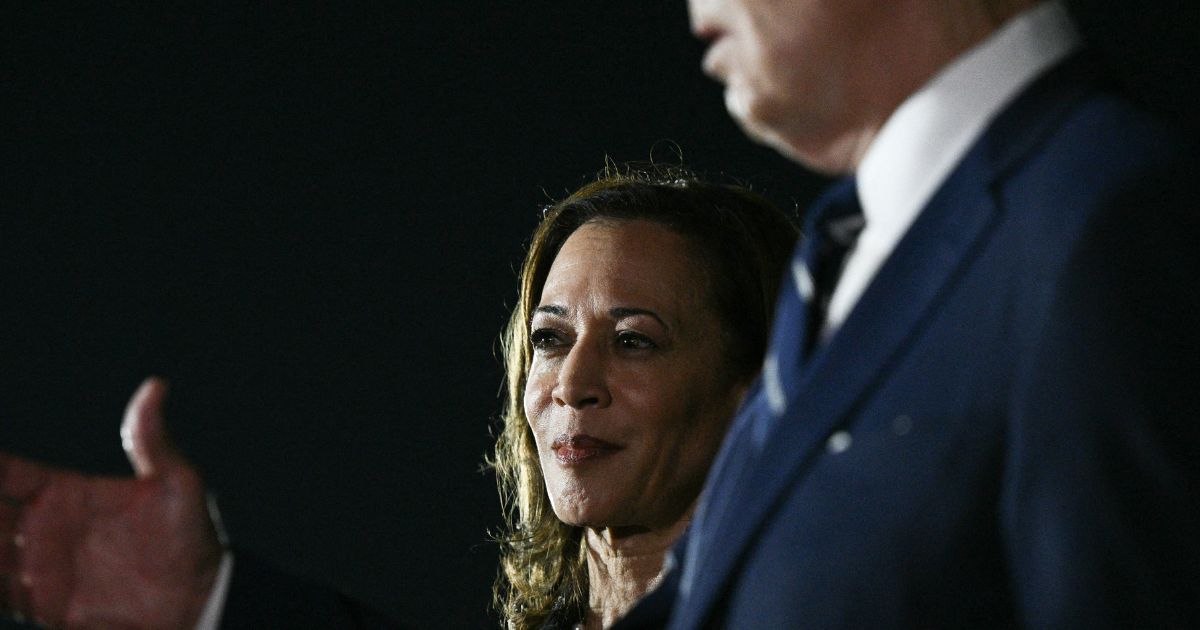 Vice President Kamala Harris looks on as President Joe Biden talks to the media after the arrival of the prisoners released by Russia at Joint Base Andrews in Maryland on Thursday.