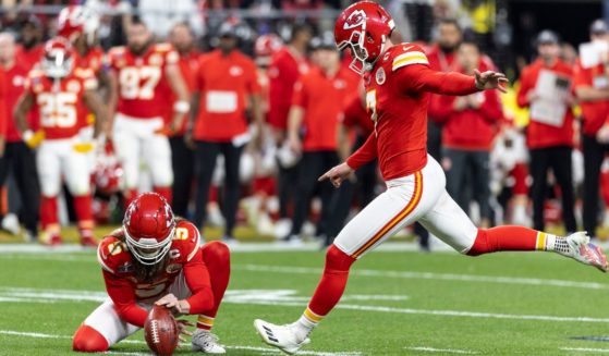 Kansas City Chiefs kicker Harrison Butker, right, kicks a field goal during Super Bowl LVIII in Las Vegas, Nevada, on Feb. 11.