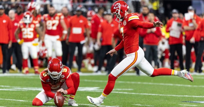 Kansas City Chiefs kicker Harrison Butker, right, kicks a field goal during Super Bowl LVIII in Las Vegas, Nevada, on Feb. 11.