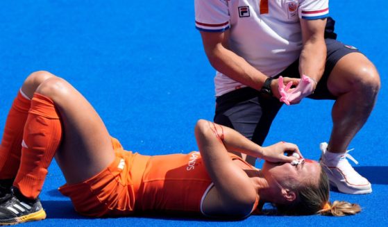 Netherlands' Joosje Burg lies on the ground after getting injured during the women's semifinal field hockey match between Argentina and Netherlands at the Yves-du-Manoir Stadium during the 2024 Summer Olympics Wednesday in Colombes, France.