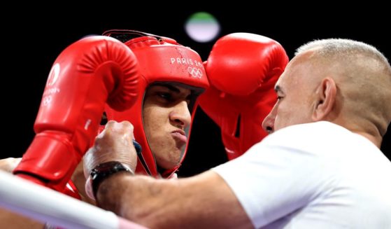 Team Algeria Coach Mohamed Al-Shawa, right, assists Imane Khelif of Team Algeria, left, before the Women's 66kg preliminary round match against Angela Carini of Team Italy in Paris, France, on Thursday.