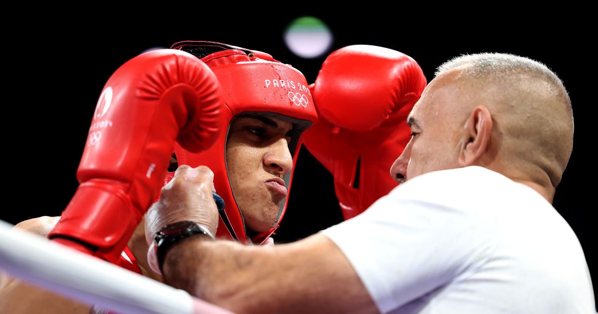 Team Algeria Coach Mohamed Al-Shawa, right, assists Imane Khelif of Team Algeria, left, before the Women's 66kg preliminary round match against Angela Carini of Team Italy in Paris, France, on Thursday.