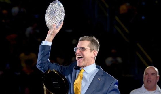 Then-head coach Jim Harbaugh of the Michigan Wolverines celebrates with the Coaches' Trophy during the Michigan Wolverines football National Championship celebration in Ann Arbor, Michigan, Jan. 13.