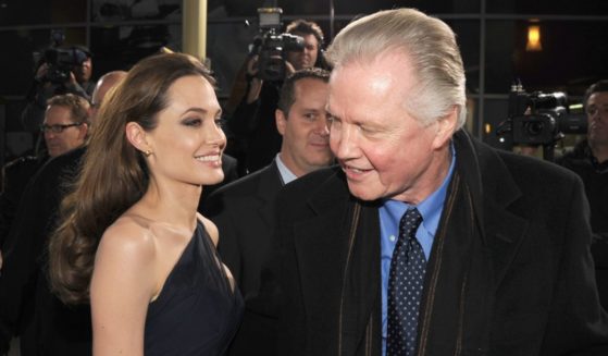 Angelina Jolie, left, and Jon Voight, right, arrive at the premiere of "In the Land of Blood and Honey" in Hollywood, California, on Dec. 8, 2011.