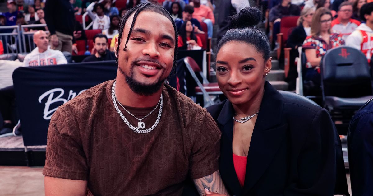 Jonathan Owens, left, and Simone Biles, right, attend a game between the Houston Rockets and the Los Angeles Lakers in Houston, Texas, on Jan. 29.