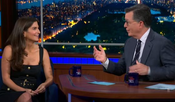 On Monday's episode of "The Late Show with Stephen Colbert," host Stephen Colbert, right, and CNN's Kaitlan Collins, left, were taken aback when the audience laughed at Colbert calling CNN "objective."